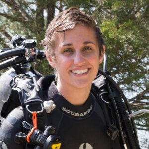 Young woman with short hair and scuba gear smiling