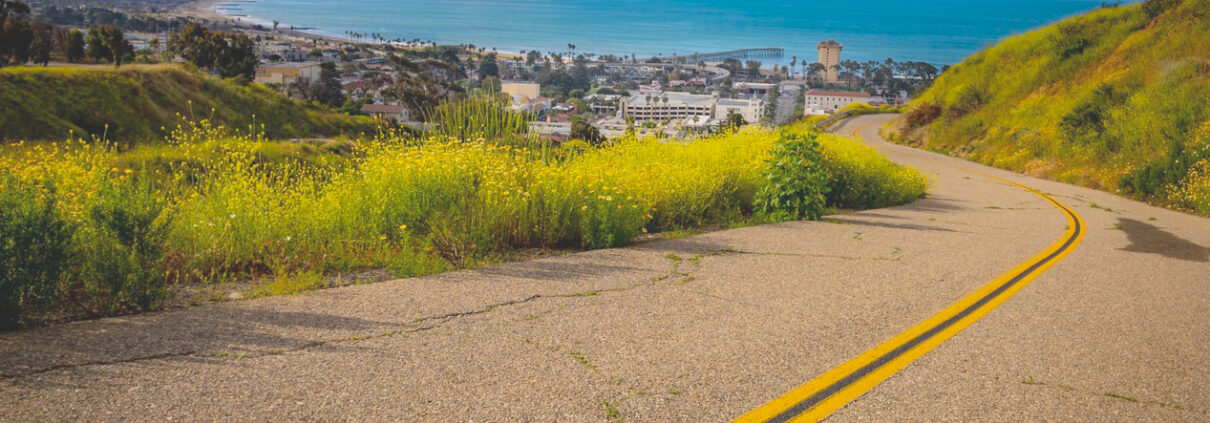 View over a highway and town towards the ocean