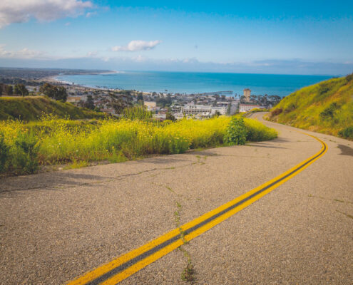 View over a highway and town towards the ocean