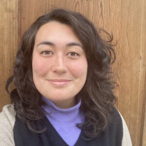 Photograph of a young woman smiling at the camera.