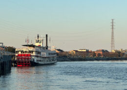 Photograph of an old steamboat in New Orleans at golden hour.